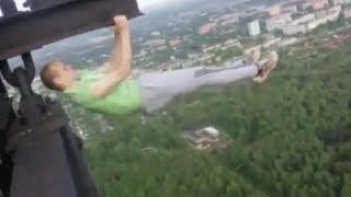 Insane Guys Hang off Electrical Tower