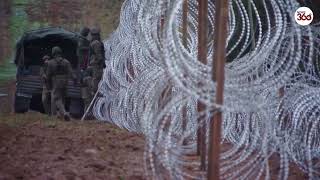 Polish soldiers build razor wire fence at border with Russia's Kaliningrad