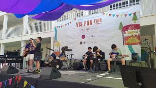 Audree on stage as a guitarist and Avro on stage as a drummer