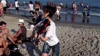 Lindsey Stirling plays the violin on the beach