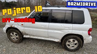 2000 Mitsubishi Pajero IO off-road drive on sand beach in seaside town 4K
