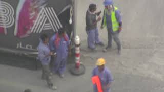People watching--workers at a construction site (raw footage)