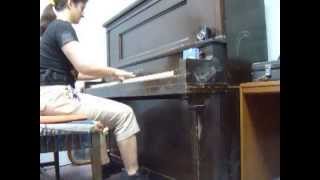 Playing the old piano at a music store practice room