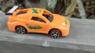 Toy car driving on the rode | orange color race car driving play video