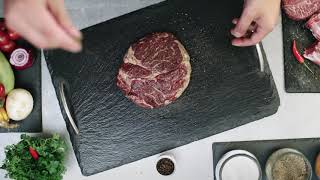 Sprinkles of salt and pepper on a raw rib-eye steak (free no copyright video with link)