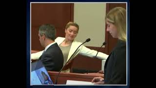 Amber smirking in court during Tara Roberts saying Johnny was bruised by Amber during an argument.