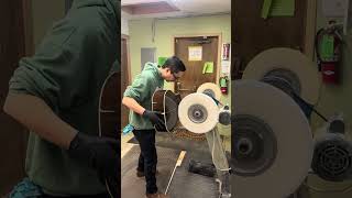 Jason Watkins from Thompson Guitars at the buffing wheel
