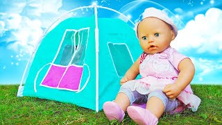 Baby Annabell doll goes camping with a new toy tent for dolls and has fun outdoors.