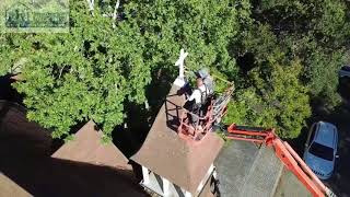 PRI Premiere Roofing Repairing and Installing Cross on Church