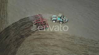 A Tractor with a Harrow Cultivates the Land. | Stock Footage - Envato elements