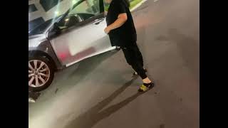 Lady trys to lift her car off towtruck