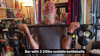 pair of 20lb kettlebells hung on a bar