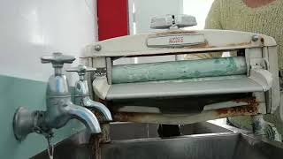 Washing the kids' clothes with a mangle - camping life