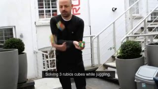 Dude solves three Rubik's Cubes while juggling them!
