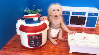 Baby monkey bebe in the kitchen making dumplings and playing with the puppy