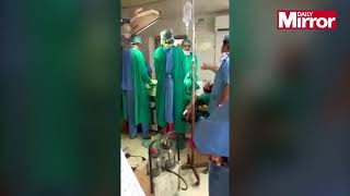 Appalling moment surgeons FIGHT as newborn baby dies after emergency cesarean birth