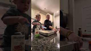 Toddler making dinner with mom. 