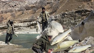A nomadic family: crossing mountain valleys to fish in a wild river
