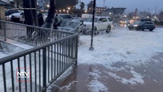 Sea foam covers the Santa Cruz coast