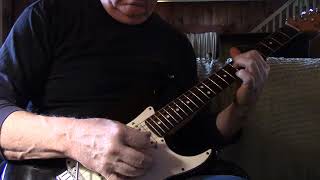practicing the guitar with a 1984 American Fender Stratocaster...