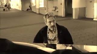 John McAfee plays piano