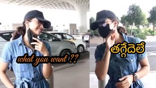 Rashmika mandanna spotted at airport , pushpa taggedele gesture